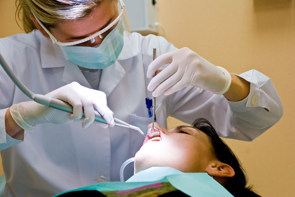 Dentist treating a patient in a dental operatory