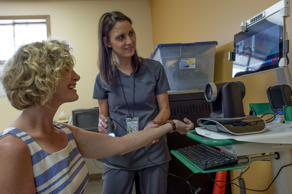 Clinician greeting a smiling patient during a community health center visit