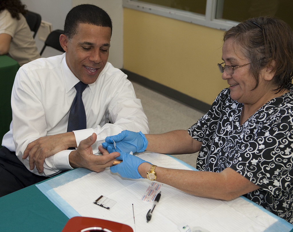 Clinician performing a health screening for a community health patient