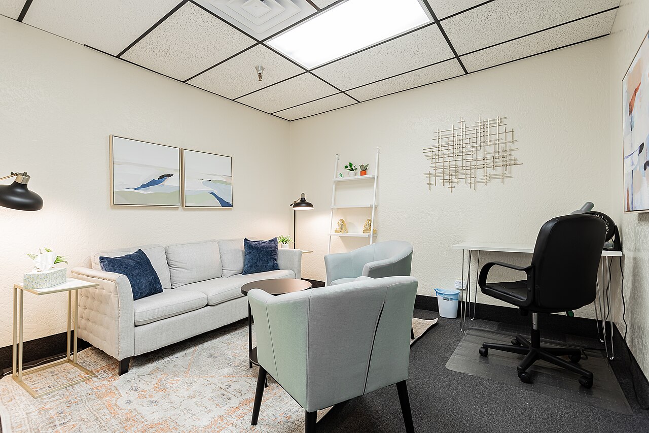Professional counseling office with a couch and chairs used for therapy sessions