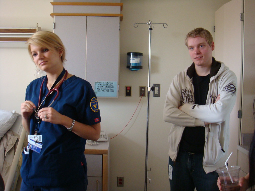 Clinician talking with a patient during an exam room visit at a community health center