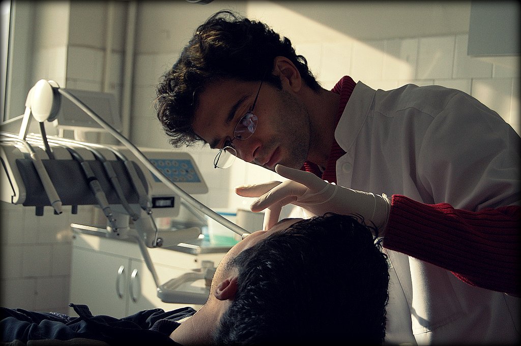 Dentist examining a patient during a routine dental exam