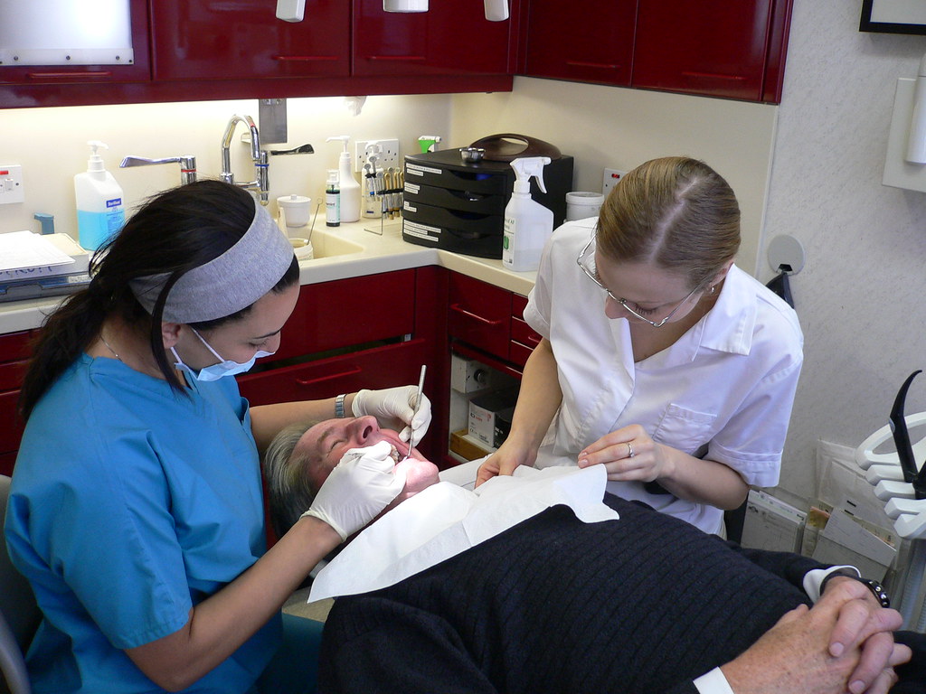 Dentist and dental assistant working together on a patient in a dental operatory