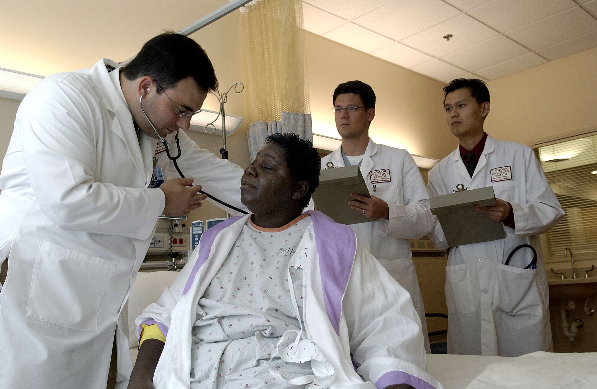 Physician examining a patient with a stethoscope during a clinic visit