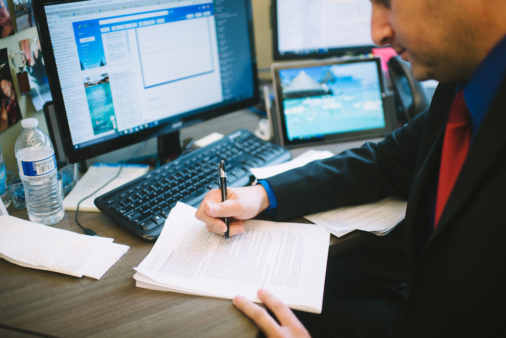 Hiring manager reviewing a healthcare resume at a desk